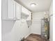 Functional laundry room with storage cabinets, shelving, and modern water heater at 6160 King Arthur Dr, Douglasville, GA 30135