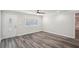 An empty room featuring wood floors, a ceiling fan, and a front door with decorative glass at 6160 King Arthur Dr, Douglasville, GA 30135