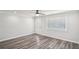 An empty room featuring wood floors, a ceiling fan, and a front door with decorative glass at 6160 King Arthur Dr, Douglasville, GA 30135