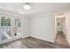 Bright living room with hardwood floors, white walls, and access to the outdoors through glass panel double doors at 6160 King Arthur Dr, Douglasville, GA 30135