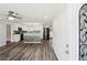 An open-concept living space with a view of the kitchen, showcasing modern appliances and stylish design at 6160 King Arthur Dr, Douglasville, GA 30135