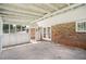 Enclosed sunroom with access to the home's interior, brick exterior, and concrete flooring at 6160 King Arthur Dr, Douglasville, GA 30135