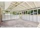 Enclosed sunroom with a neutral color scheme and multiple large windows providing lots of natural light at 6160 King Arthur Dr, Douglasville, GA 30135