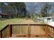 Backyard view from the deck, featuring mature trees and a car in the distance at 662 Gary Nw Rd, Atlanta, GA 30318