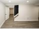 Spacious basement featuring modern flooring, neutral paint, and stairs to the upper level at 662 Gary Nw Rd, Atlanta, GA 30318