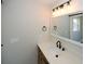 Bathroom featuring a modern vanity with a speckled countertop and black fixtures at 662 Gary Nw Rd, Atlanta, GA 30318