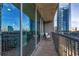 Open-air balcony featuring views of the city with glass sliding doors and metal railing at 1080 Peachtree Ne St # 1208, Atlanta, GA 30309