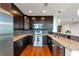 Stylish kitchen with stainless steel appliances, dark cabinetry, granite countertops, and hardwood flooring at 1080 Peachtree Ne St # 1208, Atlanta, GA 30309