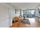 Bright living room featuring hardwood floors, modern decor, and a balcony with city views at 1080 Peachtree Ne St # 1208, Atlanta, GA 30309