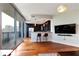 Open living area with hardwood floors, modern lighting, kitchen, and a sliding glass door to balcony at 1080 Peachtree Ne St # 1208, Atlanta, GA 30309
