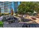Stone patio with table and benches; featuring built-in grilling area and well-manicured landscaping at 1080 Peachtree Ne St # 1208, Atlanta, GA 30309