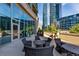 Outdoor patio with comfortable wicker seating and lush greenery at 1080 Peachtree Ne St # 1208, Atlanta, GA 30309