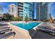 Rooftop swimming pool surrounded by lounge chairs and city views at 1080 Peachtree Ne St # 1208, Atlanta, GA 30309