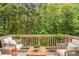 Inviting outdoor deck surrounded by lush trees perfect for entertaining at 173 Parkview Place Dr, Mcdonough, GA 30253