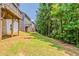 View of backyard showing lawn, trees, and home exteriors at 173 Parkview Place Dr, Mcdonough, GA 30253