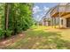 View of the spacious backyard, showing lawn and trees in the background at 173 Parkview Place Dr, Mcdonough, GA 30253