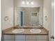 Bathroom featuring double sinks, granite countertop, and a well-lit mirror at 173 Parkview Place Dr, Mcdonough, GA 30253