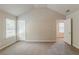 Spacious carpeted bedroom featuring neutral paint, abundant natural light, and ensuite access at 173 Parkview Place Dr, Mcdonough, GA 30253