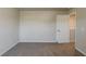 Bedroom with neutral paint, carpet flooring, and a view into the hallway at 173 Parkview Place Dr, Mcdonough, GA 30253