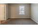 Neutral bedroom featuring carpeted floors, a large window, and natural light at 173 Parkview Place Dr, Mcdonough, GA 30253