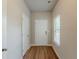 Clean entryway with wood-look floors, a white front door, a window, and a coat closet at 173 Parkview Place Dr, Mcdonough, GA 30253