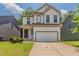 Charming two-story home featuring a two-car garage, well-maintained lawn and craftsman-style details at 173 Parkview Place Dr, Mcdonough, GA 30253