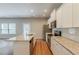 Bright kitchen featuring stainless appliances, white cabinets, granite countertops and an island at 173 Parkview Place Dr, Mcdonough, GA 30253
