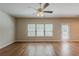 Bright living room featuring hardwood floors, neutral paint, and multiple windows allowing abundant natural light at 173 Parkview Place Dr, Mcdonough, GA 30253