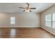 Spacious living room featuring wood-look floors, neutral paint and an overhead ceiling fan and light at 173 Parkview Place Dr, Mcdonough, GA 30253