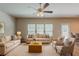 Bright living room with lots of seating, neutral walls, carpet and natural light at 173 Parkview Place Dr, Mcdonough, GA 30253
