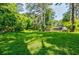 Large backyard with lush green grass and mature trees providing ample shade and privacy at 2343 Hunting Valley Dr, Decatur, GA 30033