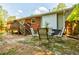 A brick patio with outdoor seating is visible in this backyard with trees and a lawn at 2343 Hunting Valley Dr, Decatur, GA 30033