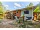 A brick patio with outdoor seating is visible in this backyard with trees and a lawn at 2343 Hunting Valley Dr, Decatur, GA 30033