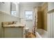 Bright bathroom featuring granite counters, beadboard walls, and a shower over tub at 2343 Hunting Valley Dr, Decatur, GA 30033