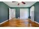 Bedroom with hardwood floors, neutral walls, bi-fold closet doors, and a bright window at 2343 Hunting Valley Dr, Decatur, GA 30033