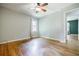 Neutral bedroom featuring hardwood floors, a ceiling fan, and a bright window at 2343 Hunting Valley Dr, Decatur, GA 30033