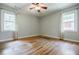 Spacious bedroom with hardwood floors, light grey walls and two windows for natural light at 2343 Hunting Valley Dr, Decatur, GA 30033