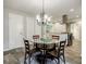 Dining area with a chandelier and glass-top table with views into the kitchen at 2343 Hunting Valley Dr, Decatur, GA 30033