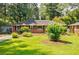 Well-maintained brick home with a lush green lawn and mature shade trees at 2343 Hunting Valley Dr, Decatur, GA 30033