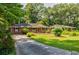 Charming brick home with well-manicured lawn, mature trees, and long driveway at 2343 Hunting Valley Dr, Decatur, GA 30033