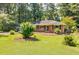 Well-maintained brick home with a lush green lawn and mature shade trees at 2343 Hunting Valley Dr, Decatur, GA 30033