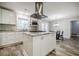 Bright kitchen with granite island, stainless hood, plentiful white cabinets, and tile floor at 2343 Hunting Valley Dr, Decatur, GA 30033