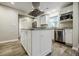 Modern kitchen featuring a central island with granite countertops, stainless steel appliances and white cabinets at 2343 Hunting Valley Dr, Decatur, GA 30033