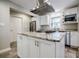 Bright kitchen with granite island, stainless hood, plentiful white cabinets, and tile floor at 2343 Hunting Valley Dr, Decatur, GA 30033