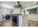 Bright kitchen with granite island, stainless hood, plentiful white cabinets, and tile floor at 2343 Hunting Valley Dr, Decatur, GA 30033