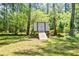 Backyard features a white storage shed, raised and ramped for easy outdoor item access at 2343 Hunting Valley Dr, Decatur, GA 30033