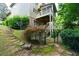 Backyard with a lush garden and stairs and a satellite dish attached to the building at 3423 Mulberry Lane Ct, Dacula, GA 30019