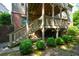 A backyard view of the deck stairs with lush landscaping and stone pavers at 3423 Mulberry Lane Ct, Dacula, GA 30019