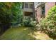 Spacious backyard featuring lush greenery and multiple deck areas with brick and siding exterior at 3423 Mulberry Lane Ct, Dacula, GA 30019