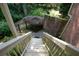 Backyard featuring wooden stairs leading down into an enclosed garden area at 3423 Mulberry Lane Ct, Dacula, GA 30019